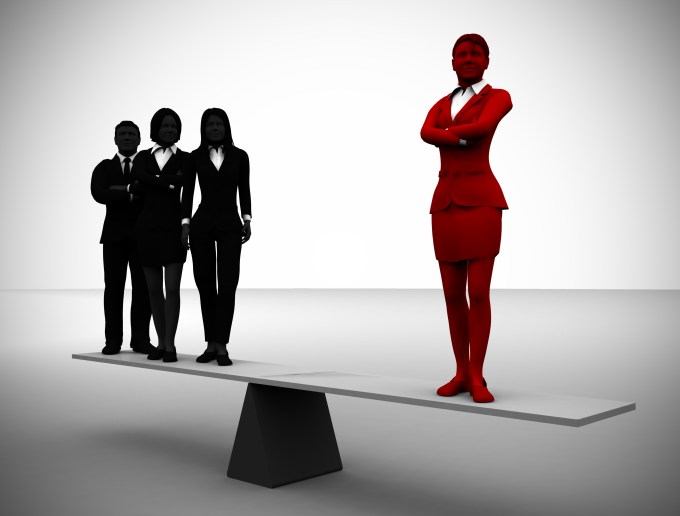 Balancing a team leader with a great team. A team of three executives stands on a balance where the counterweight is a great team leader.