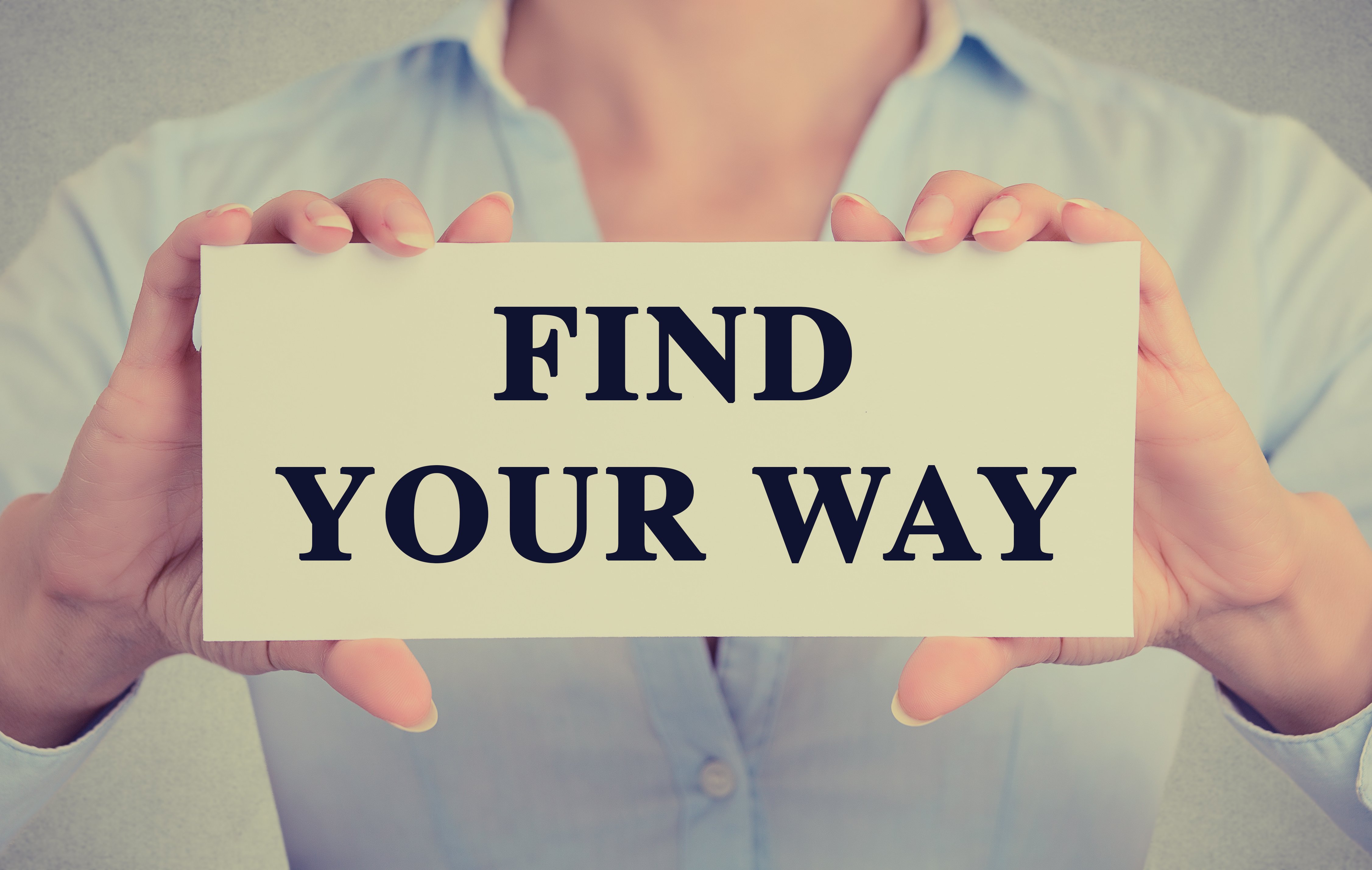 businesswoman hands holding sign find your way text message